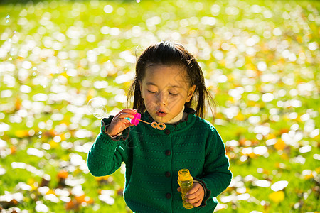 彩色图片日光秋天可爱的小女孩在户外玩耍图片