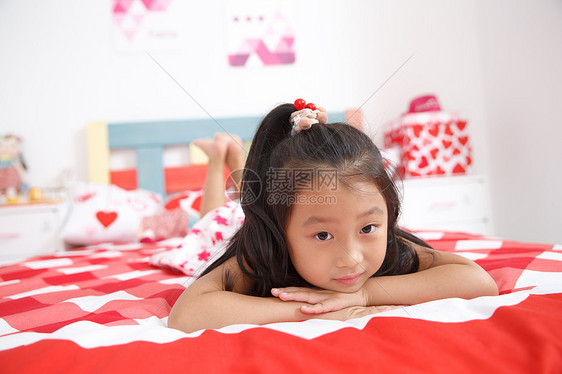 床嬉戏的仅一个女孩可爱的小女孩在卧室玩耍图片