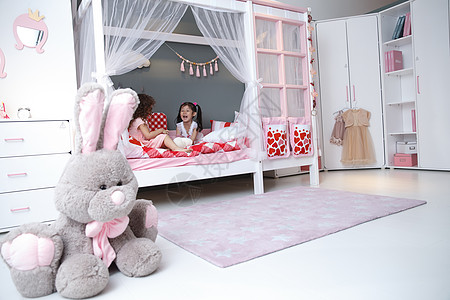 粉色室内玩具住宅内部儿童可爱的小女孩在卧室玩耍背景