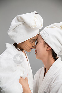 独生子家庭装扮影棚拍摄穿着浴袍的快乐母女图片