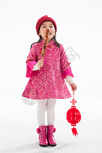 春节冬天摄影欢乐的小女孩吃糖葫芦图片