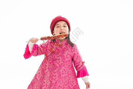健康的兴奋过年欢乐的小女孩吃糖葫芦图片