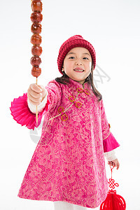 健康的东亚可爱的欢乐的小女孩吃糖葫芦图片