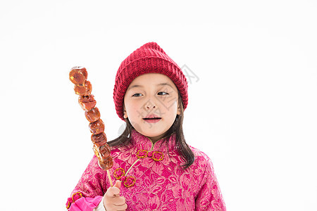 亚洲季节快乐欢乐的小女孩吃糖葫芦图片