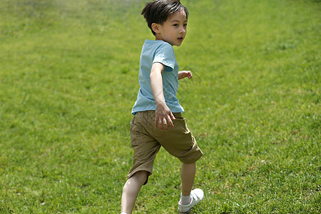 亚洲人休闲活动水平构图小男孩在草地上玩耍图片