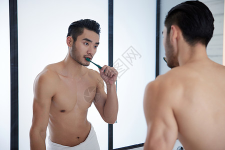 早上对着镜子刷牙的成熟男士高清图片