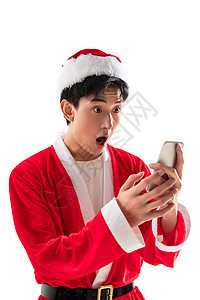 通讯节日头饰穿圣诞服的青年男人拿着手机图片