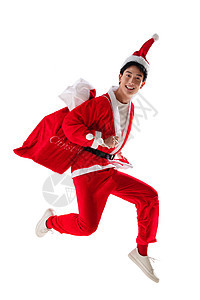 两腿分开20多岁圣诞帽穿圣诞服的青年男人背着礼物袋图片