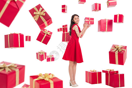 连衣裙接新年惊喜礼服漂亮的青年女人伸手接礼物背景