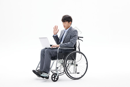 青年白领男性坐轮椅办公图片