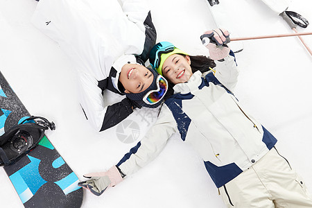 躺在地上女人玩滑雪的青年男女躺在雪地上背景