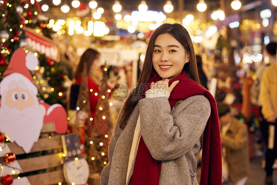 冬日女性夜晚逛圣诞市集图片