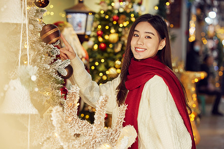 年轻美女在圣诞集市采购背景图片