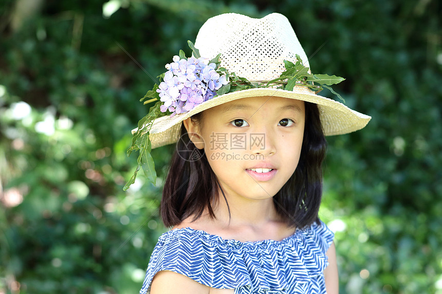 森林里帽子上花装饰的小女孩图片