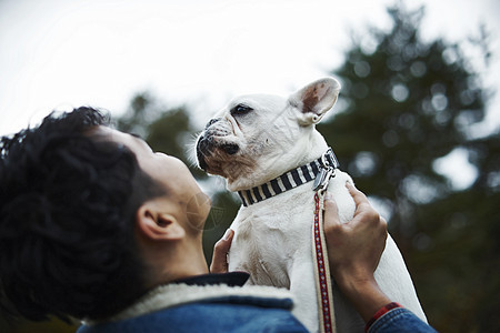 抱起爱犬的男人图片