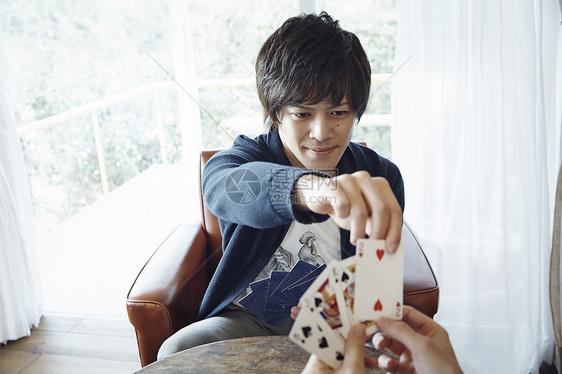 快乐时髦的年轻人玩纸牌图片