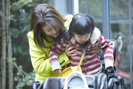 妈妈骑着自行车送孩子去上学图片素材