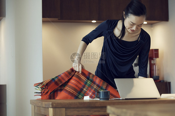 电脑前的女性拿着毛毯图片