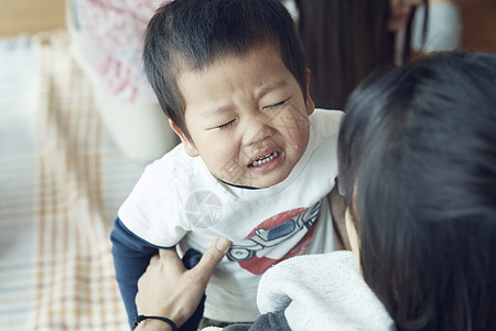 母亲安抚哭泣的小男孩图片