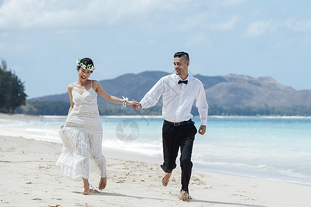 新婚夫妇走在海滩上图片