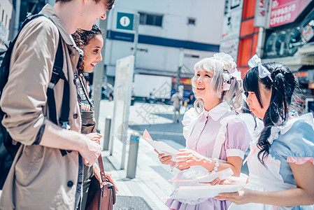 身穿角色扮演服饰的女孩和外国朋友聊天图片