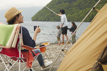 湖边露营钓鱼和喝茶的4个人图片