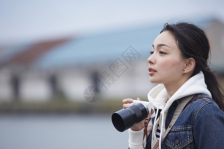 在小镇带着相机独自旅行的女性图片