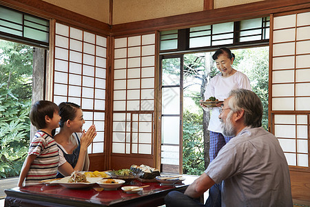 日式房屋中吃午饭的4人图片