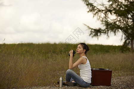 荒野旅行的女子喝水休息图片