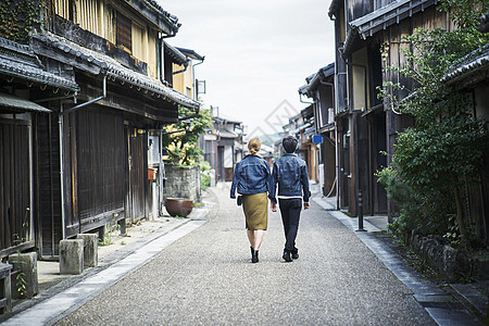 走在旅游景点路上的夫妇的背影图片