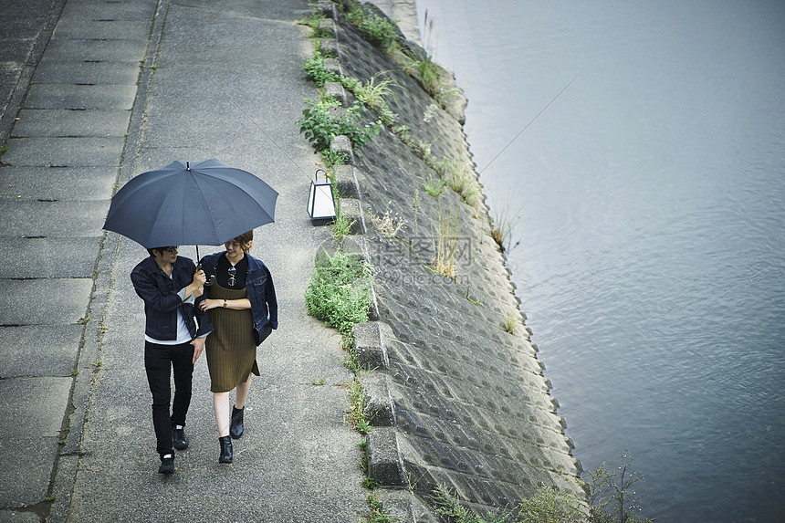 夫妇旅行雨中漫步照图片