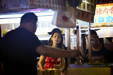 在夜市逛街的女游客图片