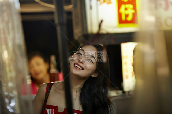 在夜市逛街的女游客在微笑图片