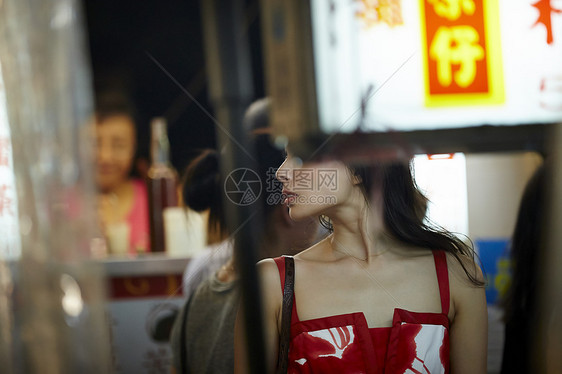 在夜市逛街的女游客侧脸图片