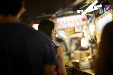 在夜市逛街的女游客图片