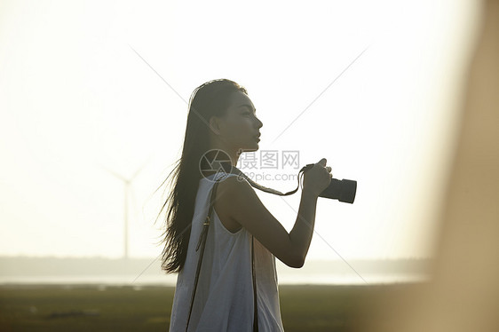 湿地旅游景点拍照的女性摄影师图片