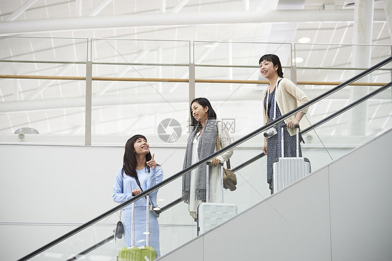 在航空站楼梯上带着行李的女人们图片