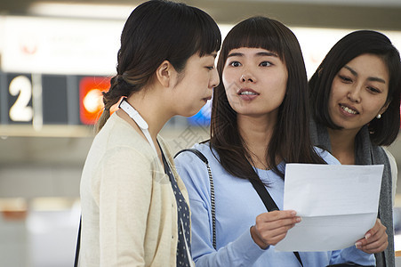 带着行李在航空站看地图的女人们图片