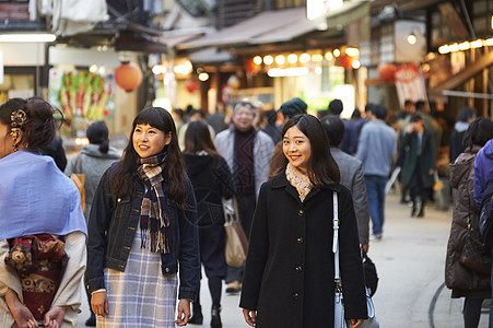 在街上人流中穿行的女游客宫岛图片