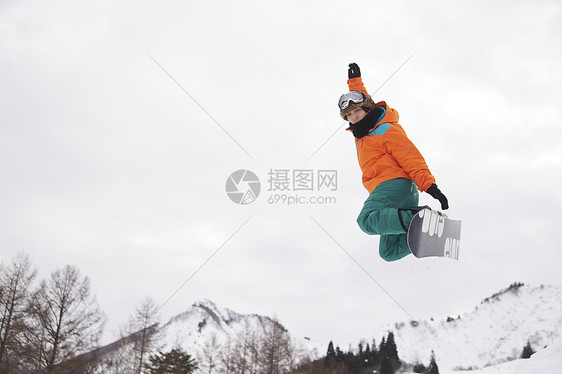 滑雪时跳起的青年男性图片