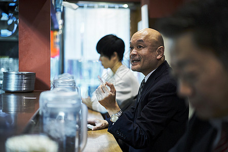 坐着等待食物上桌的男人图片