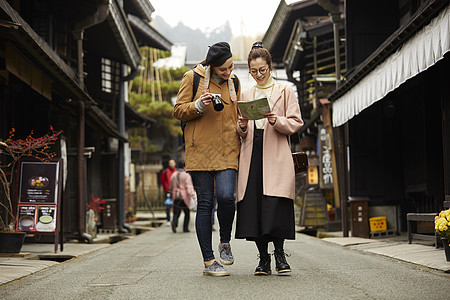 带着相机外国妇女和拿着地图的日本妇女在老街道采风岐阜县图片