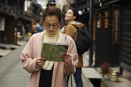 带着相机外国妇女和拿着地图的日本妇女在老街道采风岐阜县图片