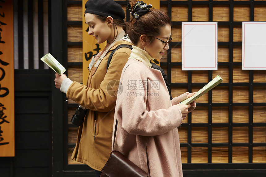 带着相机外国妇女和拿着地图的日本妇女在老街道采风岐阜县图片