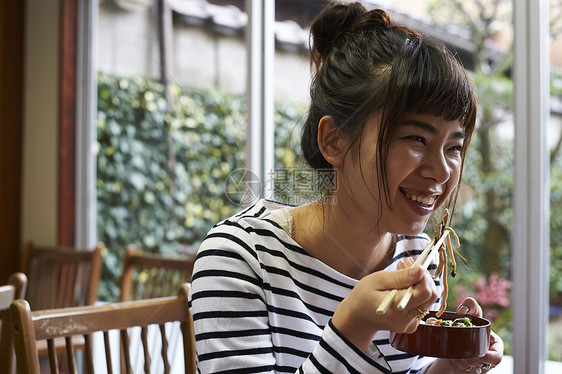 开心品尝美食的年轻女性图片