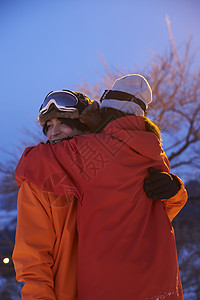 在雪地拥抱的滑雪夫妇图片