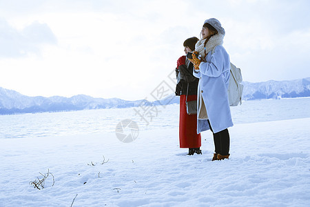 雪景区湖畔站在雪地里的少女们图片