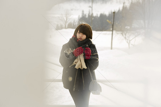 冬天在雪地里漫步的女学生图片