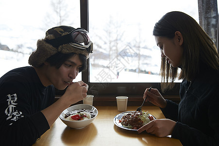 滑雪场享用午餐的年轻夫妇图片