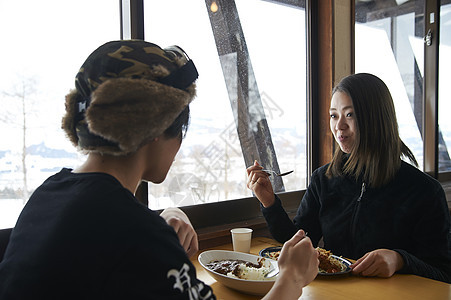 滑雪场餐厅享有午餐的年轻夫妇图片